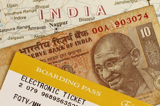 Trip to  India concept with Indian rupee and baording pass.
