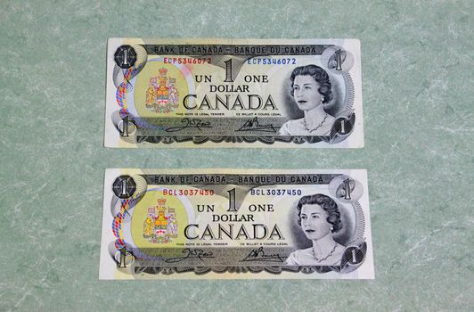 Pair of canadian dollar bills on marble background