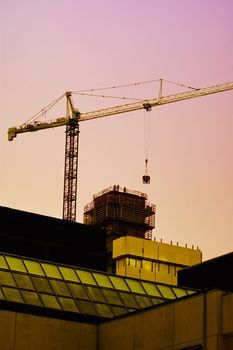 Sunset on a construction site, people working