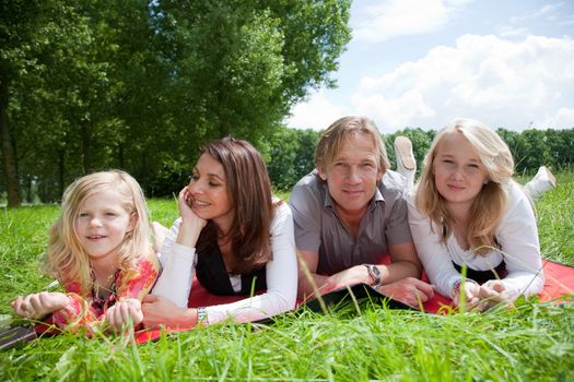 Young attractive family outdoors in the field