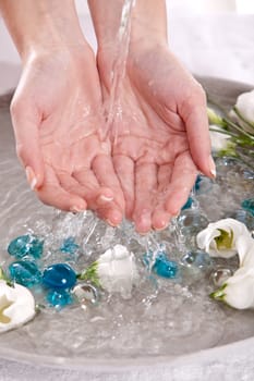 Woman holding her hands under running water