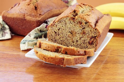 Homemade banana bread with fresh bananas. Extreme shallow DOF with selective focus on center on banana bread.