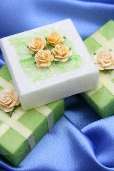 Soap gifts wrapped in green paper decorated with roses