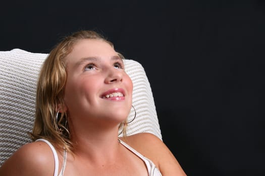 Teenage female mode sittingl on a white chair