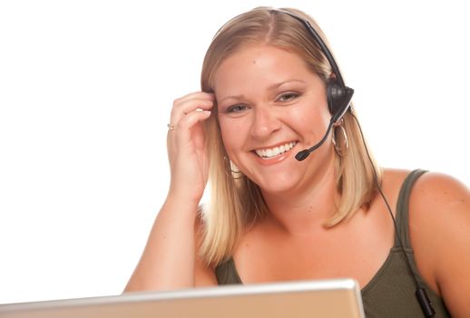 Attractive businesswoman smiles as she talks on her phone headset.