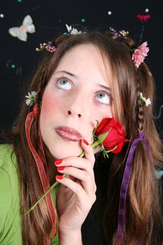 Teenage model with flowers and butterflies in her hair