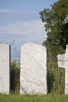 single empty granite gravestone on a grass meadow
