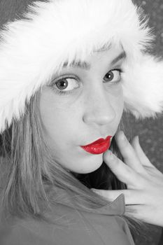 Teenager with red lips wearing a christmas hat