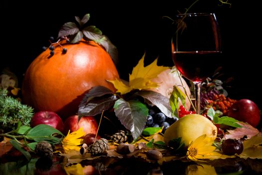 Autumn crop with red wine  isolated on black