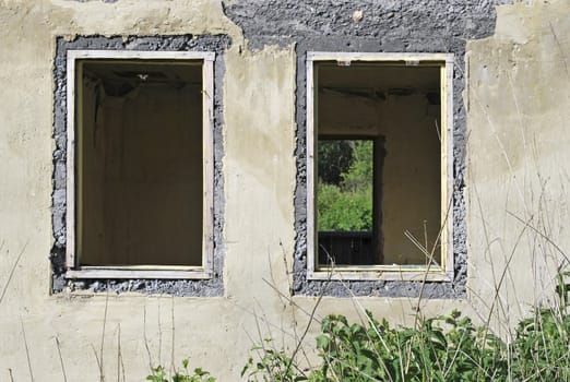 old ruined house, wall and two windows