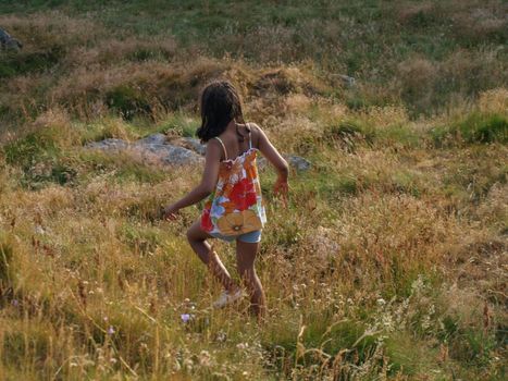 girl walking in the grass