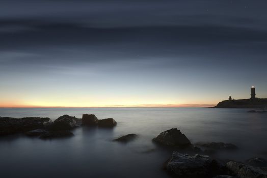 Seacoast. A decline. The sky in the light of the moon and the sun. Long exposure, a wide corner.