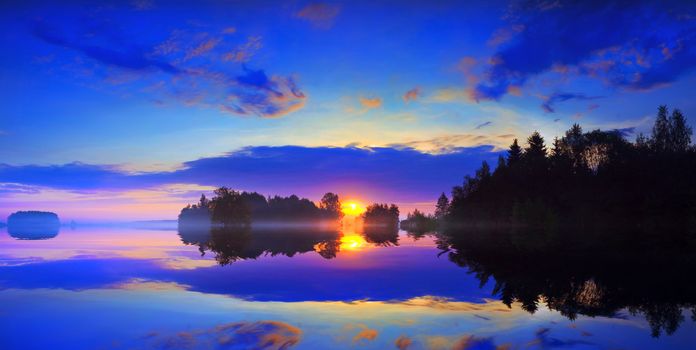 Dawn and mist over the surface of a lake.