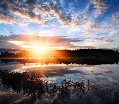 Dawn over the surface of a lake.