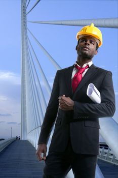 African american architect engineer with yellow hardhat and plans