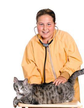 A young girl is using a stethoscope to listen to the heart of her pet cat, isolated against a white background