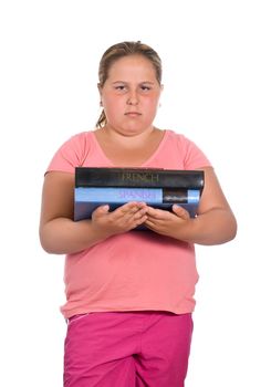 A young girl holding two language books entitled French and Spanish, and she doesn't look happy about it, isolated against a white background