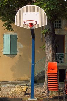 The basket appears more accessible given the strategically placed stack of chairs in the village square at Jegun in SW France
