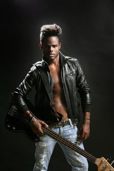 Afro american rock star musician with leather jacket and bass guitar