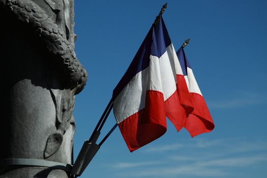 The French tricolour attached to a war memorial in SW France
