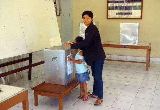 A woman voting in Indonesia's Presidential election. Tuban, Bali, Indonesia. July 8, 2009.