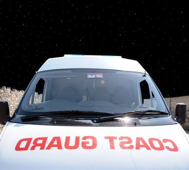 the front of a coast guard vehicle at night