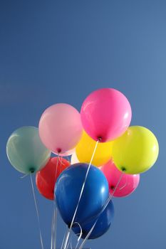 Colorful balloons in a bright blue sky