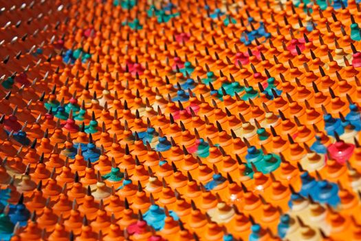 Light and shadow on a periodic structure with bases of multicolored rubber and metal needles. Used in Medicine