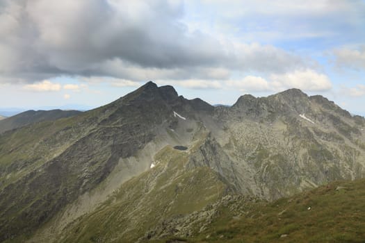 Caltun lake and important peaks (Caltun, Lespezi and in the distance Negoiu-the highest peak of this mountain range) in Fagras Mountains,from Romania.