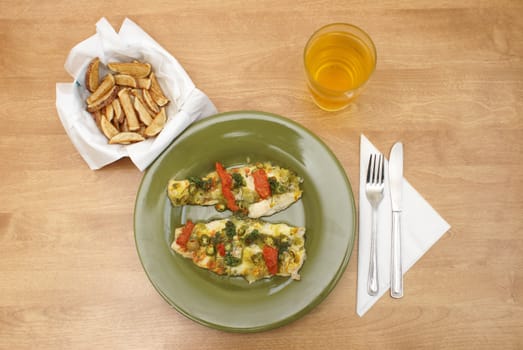 A plate of fresh fish with many seasonings, alongside a bowl of fresh cut frenchfries.