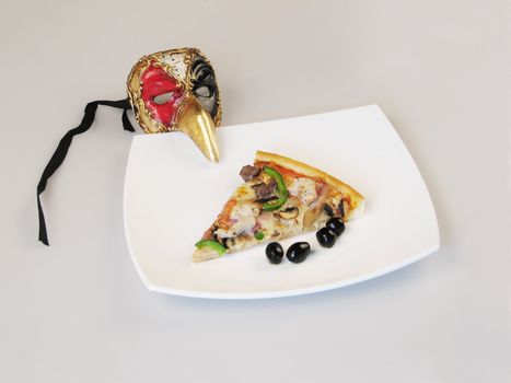 The Italian mask and pizza on a white plate