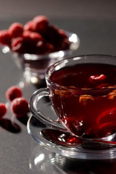 Cup of tea with raspberry and lemon
