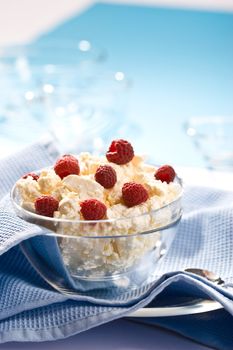 Glass bowl with soft cheese and raspberry