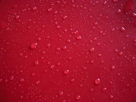 waterdrops distributed on red background