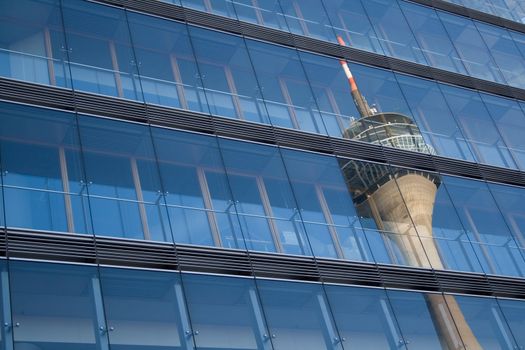 Telecommunications tower reflected in a skyscraper