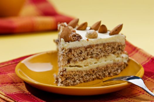 cake with almonds and nut on the yellow plate