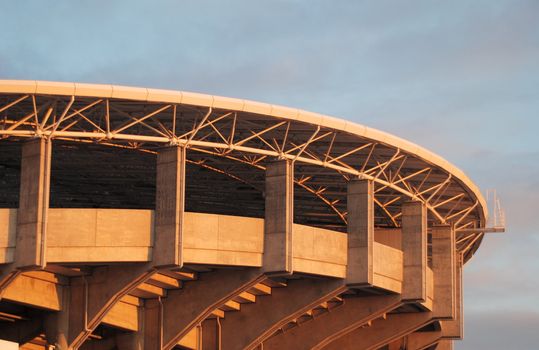 Outside of Upper tier of concrete sports stadium in evening light