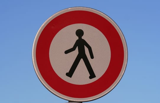 Pedestrian warning sign on a blue sky background