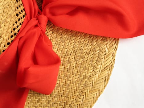 straw hat with red bow on white background