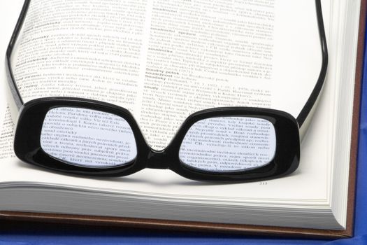 glasses (eyewear) on a book - close-up