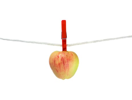 Apple on clothes line, isolated on white