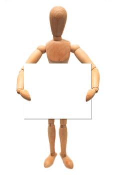 A wooden dummy, holding a white card, isolated on white.