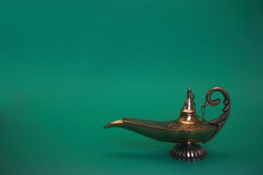 An isolated golden or bronze magic genie lamp, like Aladdins! :)