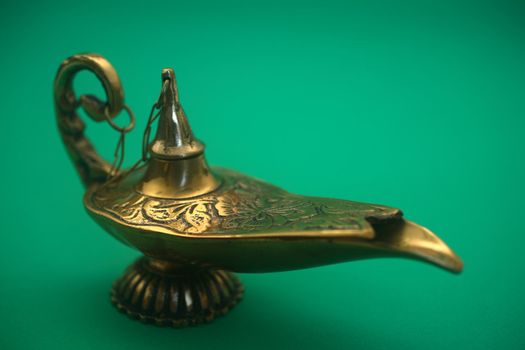 An isolated golden or bronze magic genie lamp, like Aladdins! :)