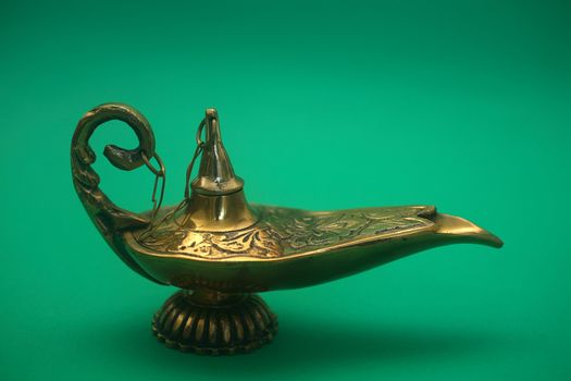 An isolated golden or bronze magic genie lamp, like Aladdins! :)