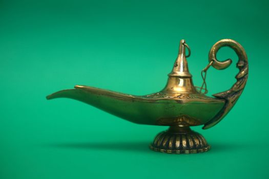 An isolated golden or bronze magic genie lamp, like Aladdins! :)