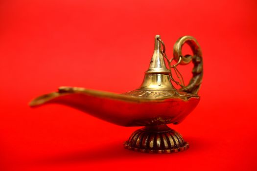 An isolated golden or bronze magic genie lamp, like Aladdins! :)