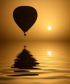 A hot air Balloon backlit by the rays of the morning Sun. 

- Luxor - Egypt

(with water reflection)