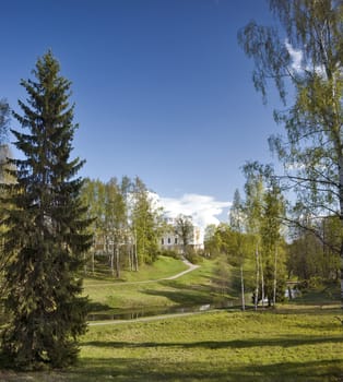 Spring park with classical building and river behind