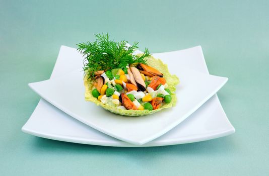 Salad of mussels with corn and peas in the leaves of savoy cabbage